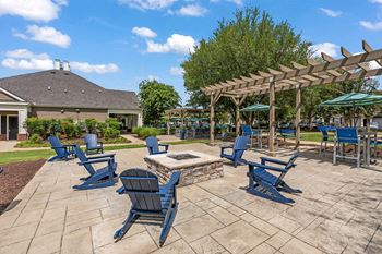 Firepit with blue chairs surrounding